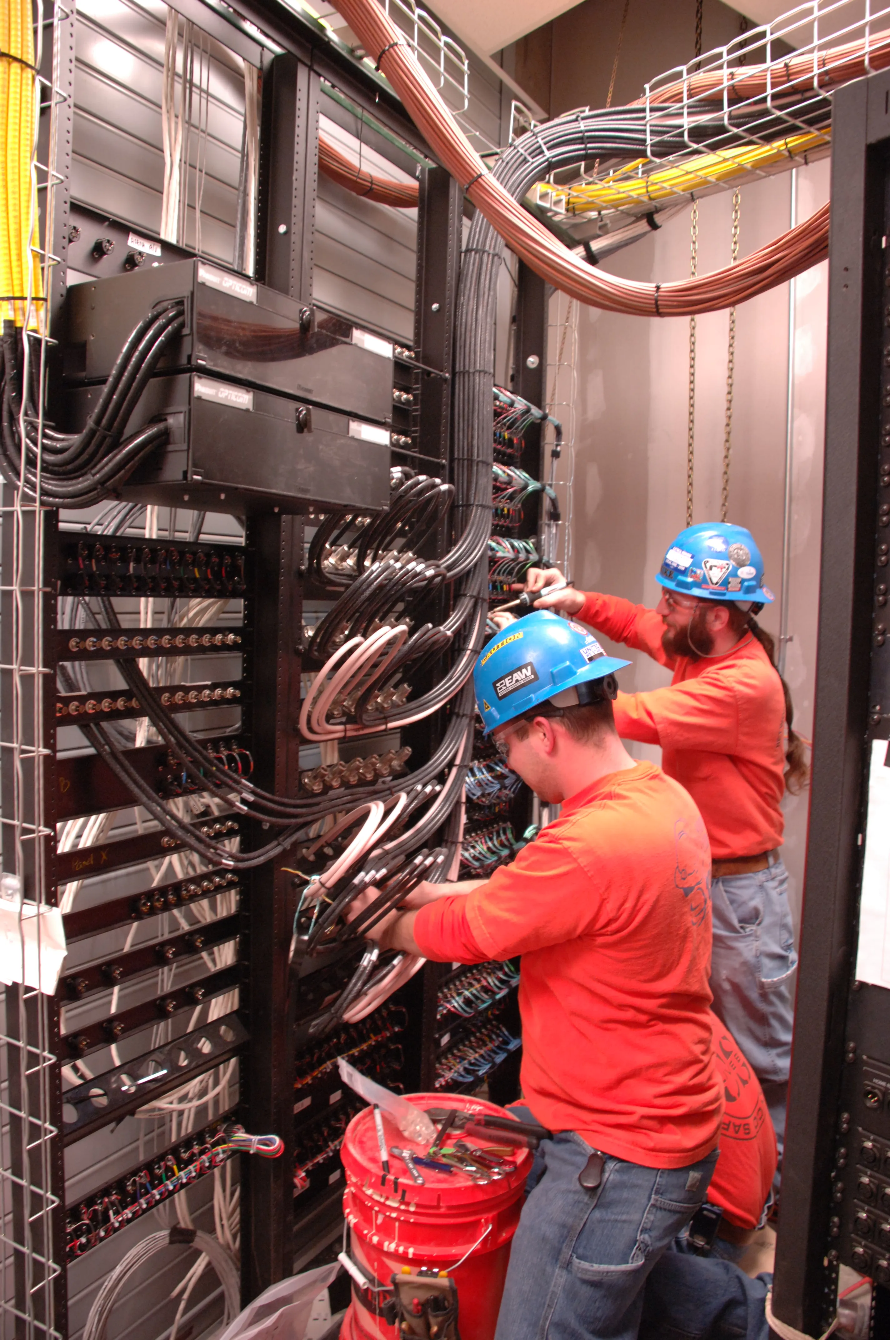 Technicians cabling a data center backbone