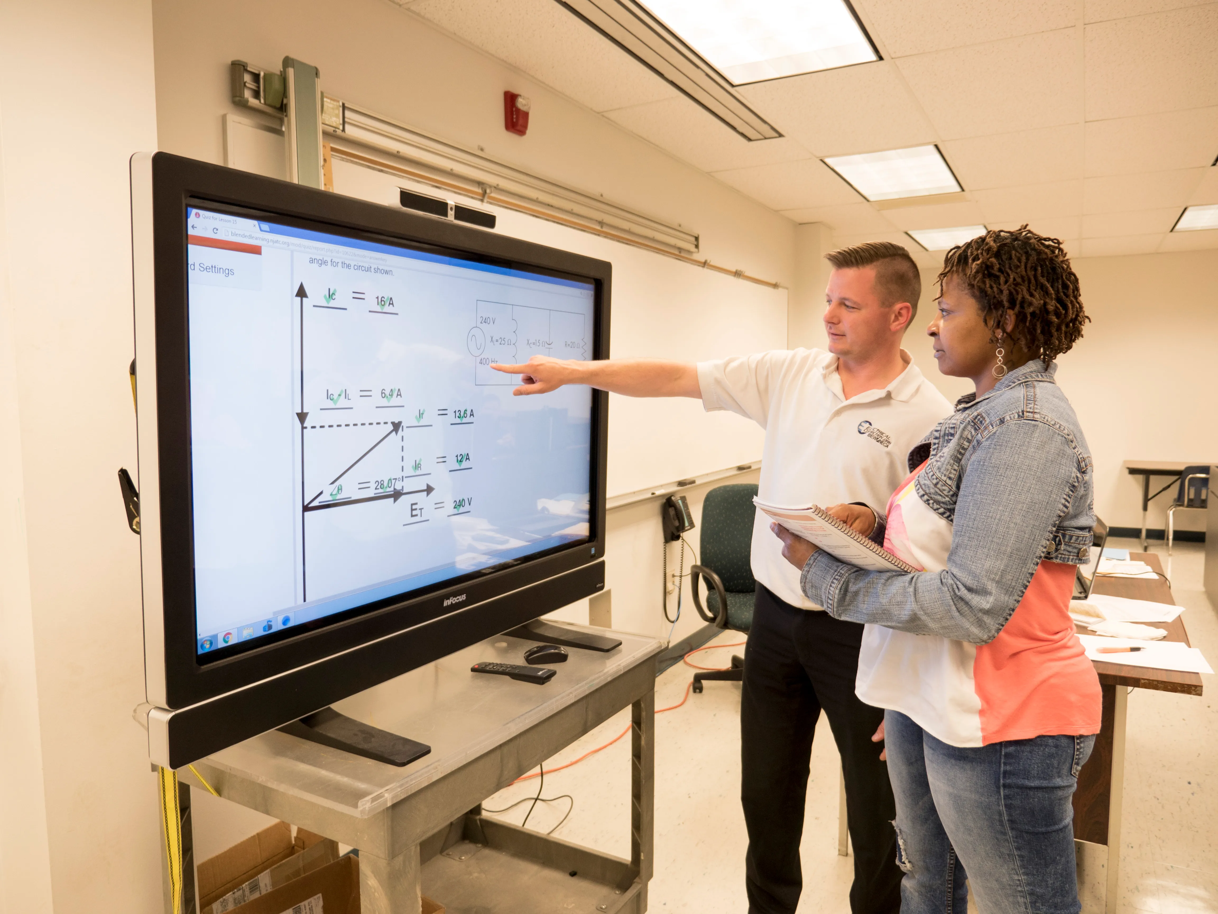 Instructor walks through a problem at the smart board